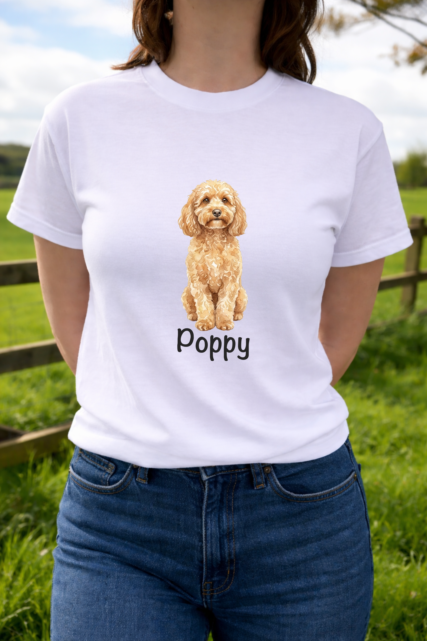 Person wearing a white t-shirt with a dog illustration and 'Poppy' text, standing outdoors.