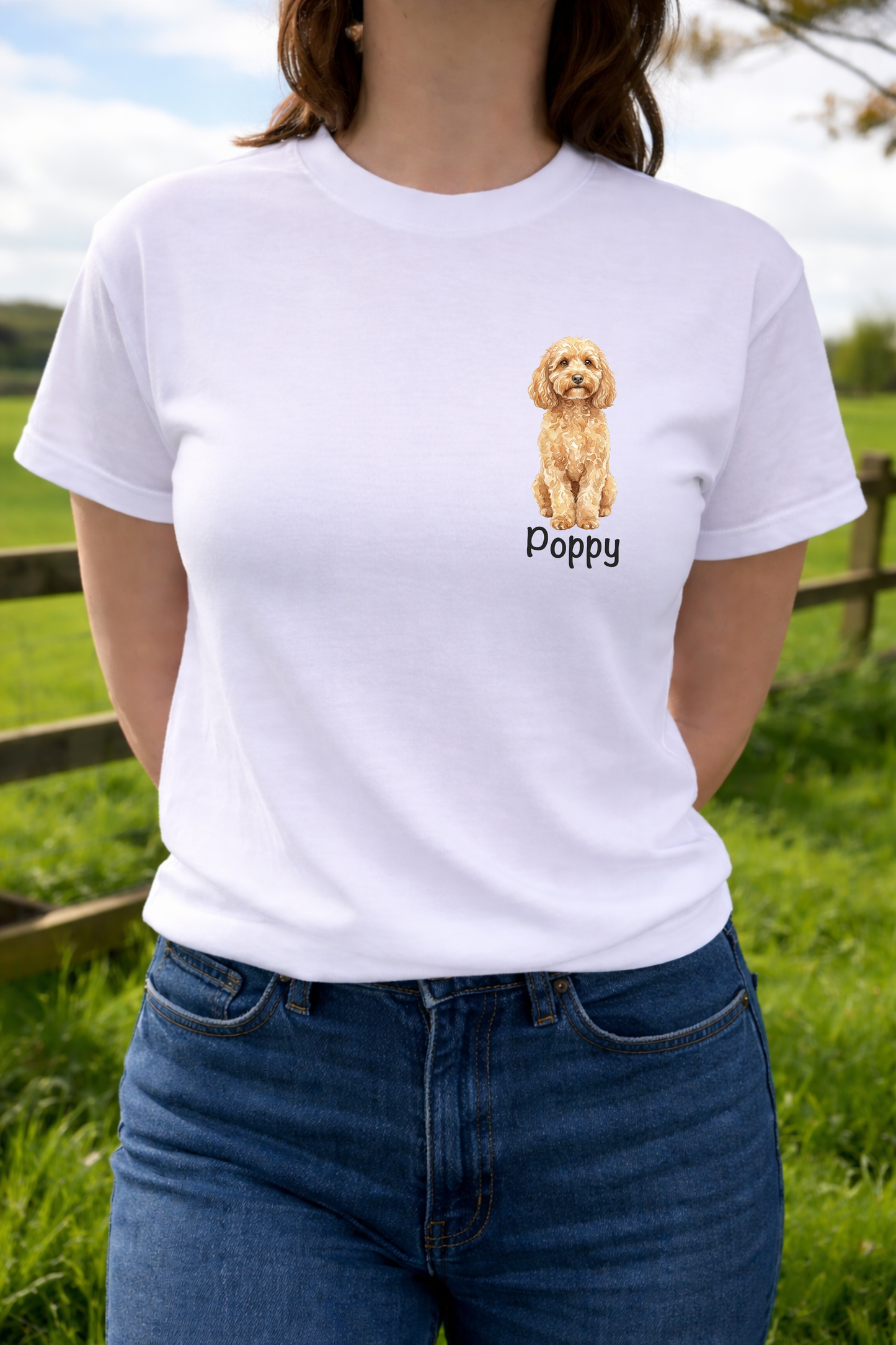 Person wearing a white t-shirt with a dog illustration and 'Poppy' text, standing outdoors.
