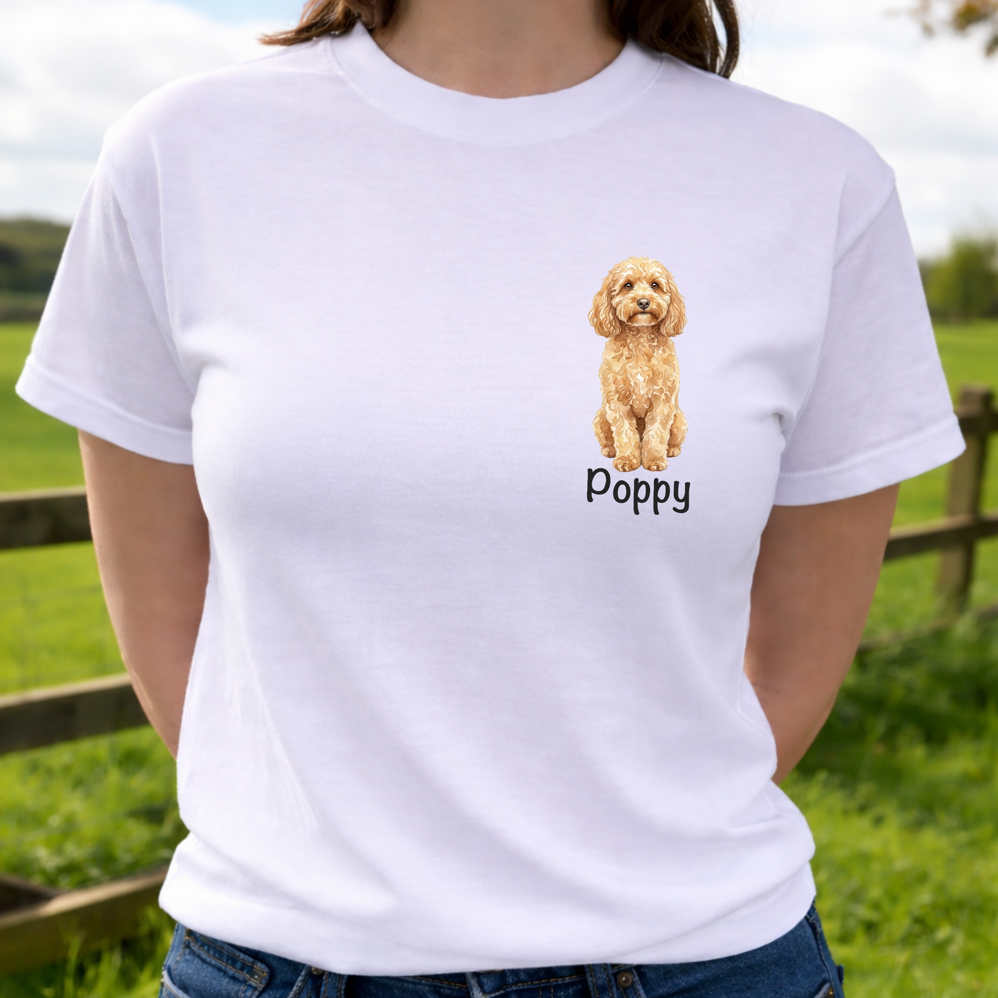 Person wearing a white t-shirt with a dog illustration and 'Poppy' text, standing outdoors.