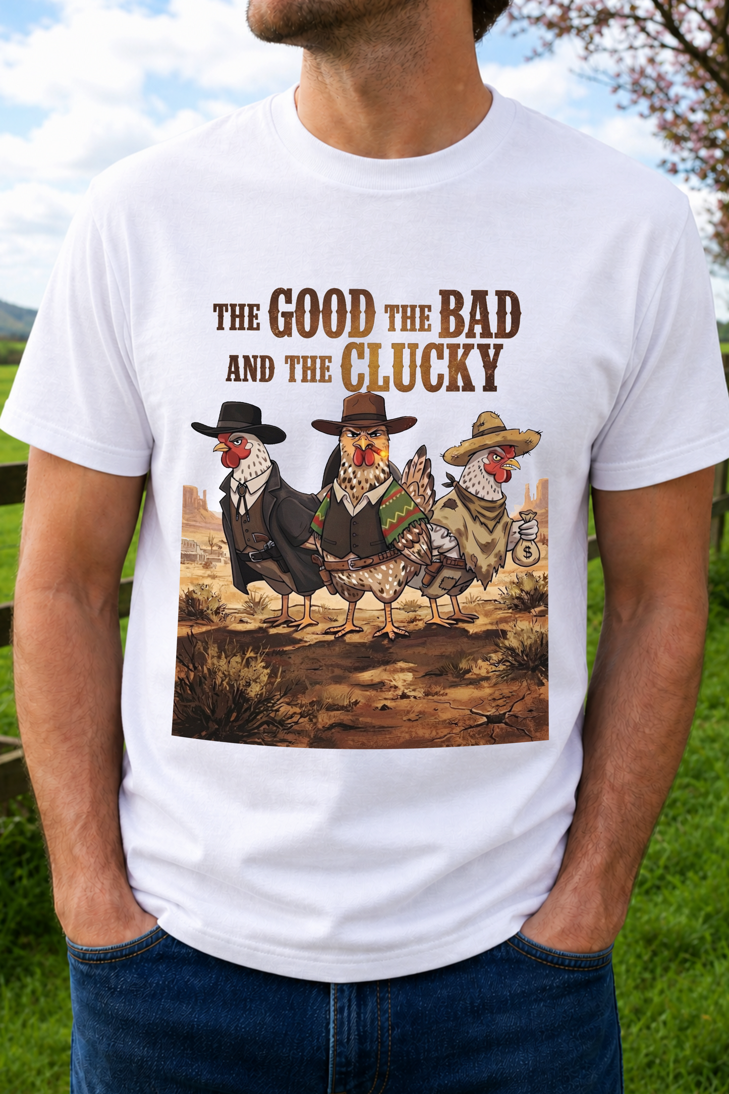 A man wearing a white graphic t-shirt with a humorous western-style chicken illustration and the text 'THE GOOD THE BAD AND THE CLUCKY'. 